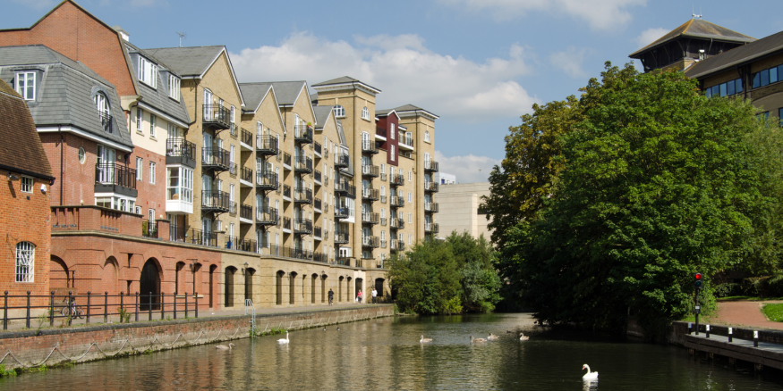 Photo of a canal street in Reading, Berkshire, with residential buildings alongside the canal walk.